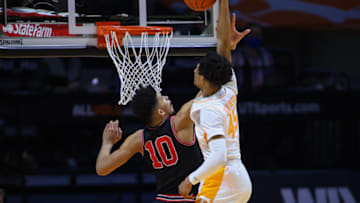 Feb 10, 2021; Knoxville, Tennessee, USA; Tennessee Volunteers guard Keon Johnson (45) dunks the ball against Georgia Bulldogs forward Toumani Camara (10) during the second half at Thompson-Boling Arena. Mandatory Credit: Randy Sartin-USA TODAY Sports