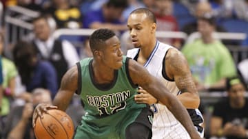 Nov 29, 2015; Orlando, FL, USA; Boston Celtics guard Terry Rozier (12) pushes back Orlando Magic guard Shabazz Napier (13) during the second half of a basketball game at Amway Center. The Magic won 110-91. Mandatory Credit: Reinhold Matay-USA TODAY Sports