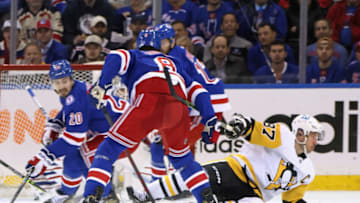 NEW YORK, NEW YORK - MAY 11: Jacob Trouba #8 of the New York Rangers checks Sidney Crosby #87 of the Pittsburgh Penguins in Game Five of the First Round of the 2022 Stanley Cup Playoffs at Madison Square Garden on May 11, 2022 in New York City. Crosby left the game shortly after the hit. (Photo by Bruce Bennett/Getty Images)