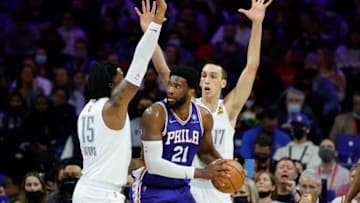 Derrick Favors #15 and Aleksej Pokusevski #17 of the Oklahoma City Thunder guard Joel Embiid #21 of the Philadelphia 76ers during the fourth quarter at Wells Fargo Center on February 11, 2022 in Philadelphia, Pennsylvania. NOTE TO USER: User expressly acknowledges and agrees that, by downloading and or using this photograph, User is consenting to the terms and conditions of the Getty Images License Agreement. (Photo by Tim Nwachukwu/Getty Images)