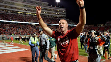 RALEIGH, NC - NOVEMBER 25: Head coach Dave Doeren of the North Carolina State Wolfpack salutes the fans after a win against the North Carolina Tar Heels at Carter Finley Stadium on November 25, 2017 in Raleigh, North Carolina. North Carolina State won 33-21. (Photo by Grant Halverson/Getty Images)