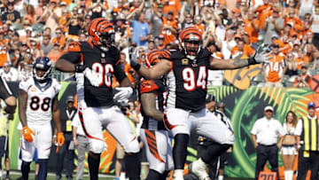Sep 25, 2016; Cincinnati, OH, USA; Cincinnati Bengals defensive tackle Domata Peko (94) and defensive end Carlos Dunlap (96) celebrate against the Denver Broncos in the second half at Paul Brown Stadium. Denver defeated the Cincinnati 29-17. Mandatory Credit: Mark Zerof-USA TODAY Sports