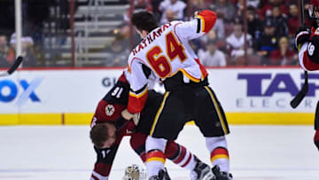 Dec 8, 2016; Glendale, AZ, USA; Calgary Flames right wing Garnet Hathaway (64) punches Arizona Coyotes left wing Max Domi (16) during the second period at Gila River Arena. Mandatory Credit: Matt Kartozian-USA TODAY Sports