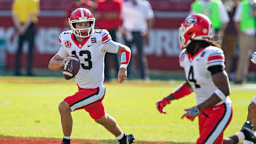 FAYETTEVILLE, AR - SEPTEMBER 26: Stetson Bennett #13 of the Georgia Bulldogs rolls out to pass during a game against the Arkansas Razorbacks at Razorback Stadium on September 26, 2020 in Fayetteville, Arkansas The Bulldogs defeated the Razorbacks 37-10. (Photo by Wesley Hitt/Getty Images)