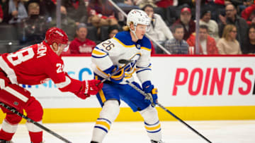 Jan 15, 2022; Detroit, Michigan, USA; St. Louis Blues defenseman Rasmus Dahlin (26) skates with the puck against Detroit Red Wings defenseman Gustav Lindstrom (28) during the first period at Little Caesars Arena. Mandatory Credit: Raj Mehta-USA TODAY Sports