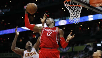 Mar 19, 2016; Atlanta, GA, USA; Houston Rockets center Dwight Howard (12) grabs a rebound over Atlanta Hawks forward Paul Millsap (4) in the third quarter at Philips Arena. Mandatory Credit: Brett Davis-USA TODAY Sports