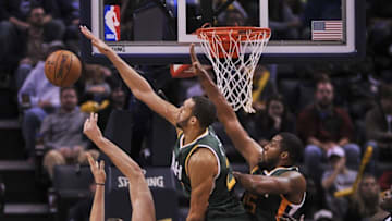 Dec 18, 2016; Memphis, TN, USA; Memphis Grizzlies center Marc Gasol (33) shoots against Utah Jazz center Rudy Gobert (27) and Utah Jazz forward Derrick Favors (15) during the second half at FedExForum. the Utah Jazz defeat the Memphis Grizzlies 82-73. Mandatory Credit: Justin Ford-USA TODAY Sports