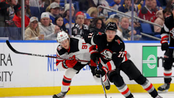 Mar 24, 2023; Buffalo, New York, USA; Buffalo Sabres left wing Victor Olofsson (71) skates with the puck as New Jersey Devils center Dawson Mercer (91) defends during the second period at KeyBank Center. Mandatory Credit: Timothy T. Ludwig-USA TODAY Sports