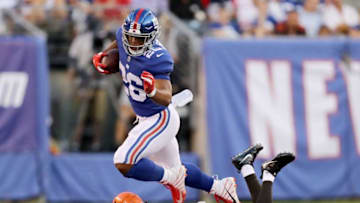 EAST RUTHERFORD, NJ - AUGUST 09: Saquon Barkley #26 of the New York Giants carries the ball as Damarious Randall #23 of the Cleveland Browns defends in the first quarter during their preseason game on August 9,2018 at MetLife Stadium in East Rutherford, New Jersey. (Photo by Elsa/Getty Images)