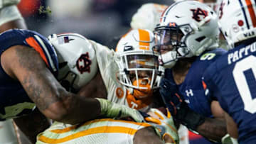 Tennessee running back Eric Gray (3) gets sandwiched between Auburn football defensive tackle DaQuan Newkirk (44) and Auburn linebacker Zakoby McClain (9) at Jordan-Hare Stadium in Auburn, Ala., on Saturday, Nov. 21, 2020. Auburn defeated Tennessee 30-17.