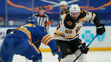 BUFFALO, NY - MARCH 18: David Krejci #46 of the Boston Bruins skates up ice with the puck as Rasmus Ristolainen #55 of the Buffalo Sabres defends during the first period at KeyBank Center on March 18, 2021 in Buffalo, New York. (Photo by Kevin Hoffman/Getty Images)