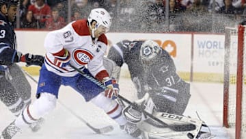 Mar 5, 2016; Winnipeg, Manitoba, CAN; Winnipeg Jets goalie Ondrej Pavelec (31) makes a save on Montreal Canadiens left wing Max Pacioretty (67) during the third period at MTS Centre. Winnipeg wins 4-2. Mandatory Credit: Bruce Fedyck-USA TODAY Sports