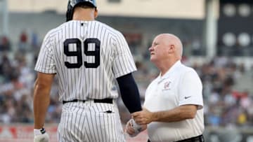 NEW YORK, NY - JULY 26: Aaron Judge #99 of the New York Yankees is looked at after he was hit by a pitch in the first inning against the Kansas City Royals at Yankee Stadium on July 26, 2018 in the Bronx borough of New York City. (Photo by Elsa/Getty Images)
