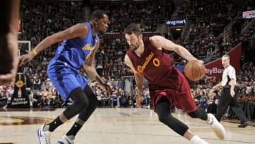 CLEVELAND, OH - DECEMBER 25: Kevin Love #0 of the Cleveland Cavaliers drives to the basket against Kevin Durant #35 of the Golden State Warriors during the game on December 25, 2016 at Quicken Loans Arena in Cleveland, Ohio. NOTE TO USER: User expressly acknowledges and agrees that, by downloading and/or using this Photograph, user is consenting to the terms and conditions of the Getty Images License Agreement. Mandatory Copyright Notice: Copyright 2016 NBAE (Photo by David Liam Kyle/NBAE via Getty Images)