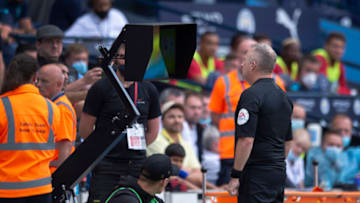 MANCHESTER, ENGLAND - SEPTEMBER 18: Referee Jonathan Moss goes over to the pitchside VAR screen to check his decision to award a penalty to Southampton and send off Kyle Walker of Manchester City during the Premier League match between Manchester City and Southampton at Etihad Stadium on September 18, 2021 in Manchester, England. (Photo by Joe Prior/Visionhaus)