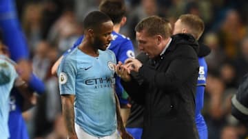 Leicester City's Northern Irish manager Brendan Rodgers (R) talks with Manchester City's English midfielder Raheem Sterling (L) (Photo credit should read OLI SCARFF/AFP via Getty Images)