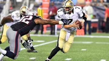 Aug 11, 2016; Foxborough, MA, USA; New Orleans Saints quarterback Luke McCown (7) breaks a tackle from New England Patriots free safety Devin McCourty (32) during a preseason NFL game at Gillette Stadium. The Patriots won 34-22. Mandatory Credit: Brian Fluharty-USA TODAY Sports