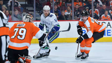 PHILADELPHIA, PENNSYLVANIA - FEBRUARY 04: Carter Hart #79 of the Philadelphia Flyers makes a save on a shot by Tyler Motte #64 of the Vancouver Canucks as Shayne Gostisbehere #53 of the Flyers looks to clear the puck during the first period at Wells Fargo Center on February 04, 2019 in Philadelphia, Pennsylvania. (Photo by Drew Hallowell/Getty Images)