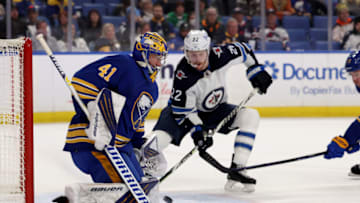 Mar 30, 2022; Buffalo, New York, USA; Buffalo Sabres goaltender Craig Anderson (41) makes a save as Winnipeg Jets center Mason Appleton (22) waits for a rebound during the third period at KeyBank Center. Mandatory Credit: Timothy T. Ludwig-USA TODAY Sports