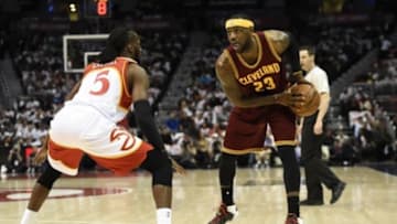 Cleveland Cavaliers forward LeBron James (23) holds the ball as Atlanta Hawks forward DeMarre Carroll (5) defends during the first half at Philips Arena. Mandatory Credit: Dale Zanine-USA TODAY Sports