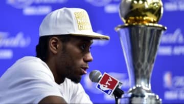 Jun 15, 2014; San Antonio, TX, USA; San Antonio Spurs forward Kawhi Leonard (2) speaks during a press conference next to the NBA Finals MVP trophy after game five of the 2014 NBA Finals against the Miami Heat at AT&T Center. Mandatory Credit: Bob Donnan-USA TODAY Sports