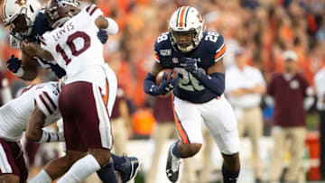 AUBURN, AL - SEPTEMBER 28: Running back JaTarvious Whitlow #28 of the Auburn Tigers looks to run the ball by linebacker Leo Lewis #10 of the Mississippi State Bulldogs during the first quarter at Jordan-Hare Stadium on September 28, 2019 in Auburn, AL. (Photo by Michael Chang/Getty Images)