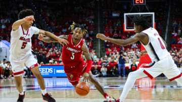 Dec 22, 2022; Raleigh, North Carolina, USA; Louisville Cardinals guard El Ellis (3) tries to break through guard Jack Clark (5) and guard Terquavion Smith (0) during the second half against North Carolina State Wolfpack at PNC Arena. Mandatory Credit: Jaylynn Nash-USA TODAY Sports