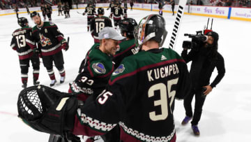 GLENDALE, ARIZONA - NOVEMBER 16: Goalie Darcy Kuemper #35 of the Arizona Coyotes is congratulated by teammate Antti Raanta #32 following his 3-0 shutout victory against the Calgary Flames at Gila River Arena on November 16, 2019 in Glendale, Arizona. Kuemper was playing in his 200th career NHL game. (Photo by Norm Hall/NHLI via Getty Images)