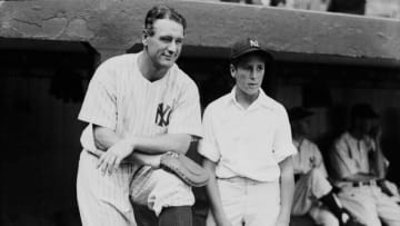 BRONX, NY - 1937: Lou Gehrig #4 of the New York Yankees and a young fan pose on the dugout steps during the 1937 season at Yankee Stadium in the Bronx, New York. (Photo by Kidwiler Collection/Diamond Images/Getty Images)