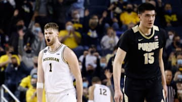 Feb 10, 2022; Ann Arbor, Michigan, USA; Michigan Wolverines center Hunter Dickinson (1) celebrates during the second half as Purdue Boilermakers center Zach Edey (15) reacts at Crisler Center. Mandatory Credit: Rick Osentoski-USA TODAY Sports