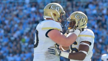 CHAPEL HILL, NC - NOVEMBER 05: Dedrick Mills #26 celebrates with teammate Andrew Marshall #50 of the Georgia Tech Yellow Jackets after scoring a touchdown against the North Carolina Tar Heels during the game at Kenan Stadium on November 5, 2016 in Chapel Hill, North Carolina. (Photo by Grant Halverson/Getty Images)