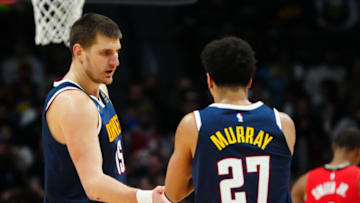 Denver Nuggets center Nikola Jokic (15) and guard Jamal Murray (27). Mandatory Credit: Ron Chenoy-USA TODAY Sports