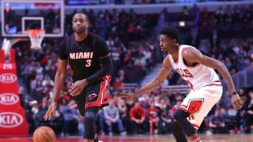 Mar 11, 2016; Chicago, IL, USA; Miami Heat guard Dwyane Wade (3) is defended by Chicago Bulls guard Justin Holiday (7) during the second half at the United Center. Miami won 118-96. Mandatory Credit: Dennis Wierzbicki-USA TODAY Sports