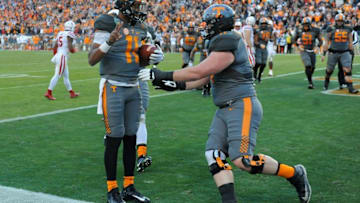 Dec 30, 2016; Nashville , TN, USA; Tennessee Volunteers quarterback Joshua Dobbs (11) celebrates with Tennessee Volunteers offensive lineman Dylan Wiesman (71) after a touchdown during the first half against the Nebraska Cornhuskers at Nissan Stadium. Mandatory Credit: Christopher Hanewinckel-USA TODAY Sports