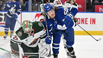 Oct 14, 2023; Toronto, Ontario, CAN; Toronto Maple Leafs forward Tyler Bertuzzi (59) bumps into Minnesota Wild goalie Filip Gustavsson (32) in the first period at Scotiabank Arena. Mandatory Credit: Dan Hamilton-USA TODAY Sports