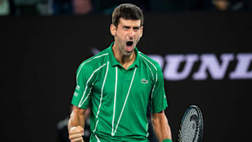 MELBOURNE, AUSTRALIA - FEBRUARY 02: Novak Djokovic of Serbia celebrates with the men's singles trophy after beating Dominic Thiem of Austria in the final on day fourteen of the 2020 Australian Open at Melbourne Park on February 02, 2020 in Melbourne, Australia. (Photo by TPN/Getty Images)