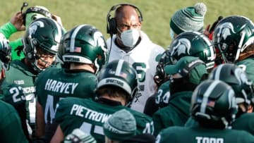 Michigan State head coach Mel Tucker talks to players during a timeout during the second half against Ohio State at the Spartan Stadium in East Lansing on Saturday, Dec. 5, 2020.