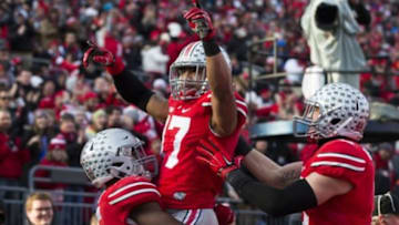 Nov 22, 2014; Columbus, OH, USA; Ohio State Buckeyes running back Ezekiel Elliott (l) and tight end Jeff Heuerman (r) celebrate with running back Jalin Marshall (17) after Marshall scored against the Indiana Hoosiers at Ohio Stadium. Ohio State won the game 42-27. Mandatory Credit: Greg Bartram-USA TODAY Sports