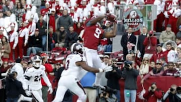 Nov 15, 2014; Tuscaloosa, AL, USA; Alabama Crimson Tide wide receiver Amari Cooper (9) catches a touchdown pass defended by Mississippi State Bulldogs defensive back Jay Hughes (3) in the second quarter at Bryant-Denny Stadium. Mandatory Credit: Marvin Gentry-USA TODAY Sports