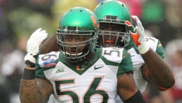 Dec 27, 2014; Shreveport, LA, USA; Miami Hurricanes linebacker Raphael Kirby (56) celebrates with defensive lineman Calvin Heurtelou (93) after a tackle in the first quarter against the South Carolina Gamecocks in the 2014 Independence Bowl at Independence Stadium. Mandatory Credit: Nelson Chenault-USA TODAY Sports