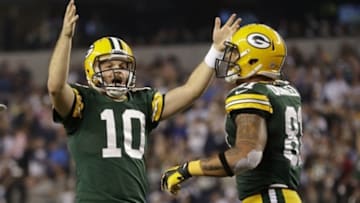 Dec 15, 2013; Arlington, TX, USA; Green Bay Packers quarterback Matt Flynn (10) reacts to a touchdown with tight end Andrew Quarless (81) in the fourth quarter at AT