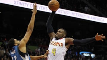 Nov 9, 2015; Atlanta, GA, USA; Atlanta Hawks forward Paul Millsap (4) attempts a dunk over Minnesota Timberwolves center Karl-Anthony Towns (32) in the fourth quarter at Philips Arena. The Timberwolves defeated the Hawks 117-107. Mandatory Credit: Brett Davis-USA TODAY Sports