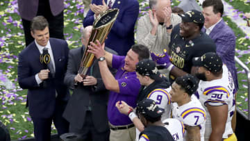 NEW ORLEANS, LOUISIANA - JANUARY 13: Head coach Ed Orgeron of the LSU Tigers and Joe Burrow #9 of the LSU Tigers celebrate their 42-25 win over The Clemson Tigers in the College Football Playoff National Championship game at Mercedes Benz Superdome on January 13, 2020 in New Orleans, Louisiana. (Photo by Sean Gardner/Getty Images)