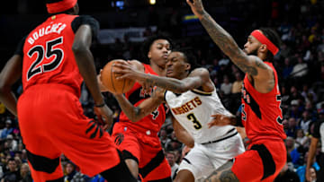 Mar 12, 2022; Denver, Colorado, USA; Denver Nuggets guard Bones Hyland (3) drives between Toronto Raptors forward Scottie Barnes (4). Mandatory Credit: John Leyba-USA TODAY Sports