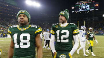 Jan 8, 2023; Green Bay, Wisconsin, USA; Green Bay Packers quarterback Aaron Rodgers (12) and wide receiver Randall Cobb (18) walk off the field following the game against the Detroit Lions at Lambeau Field. Mandatory Credit: Jeff Hanisch-USA TODAY Sports