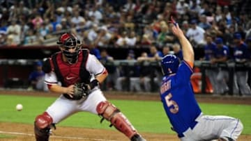 Apr 14, 2014; Phoenix, AZ, USA; New York Mets third baseman David Wright (5) scores as Arizona Diamondbacks catcher Miguel Montero (26) drops the ball during the fifth inning at Chase Field. Mandatory Credit: Matt Kartozian-USA TODAY Sports