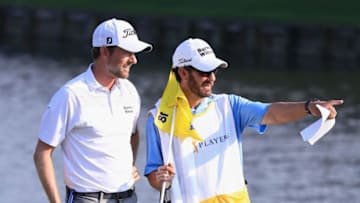 PONTE VEDRA BEACH, FL - MAY 11: Webb Simpson of the United States talks with his caddie on the 18th green during the second round of THE PLAYERS Championship on the Stadium Course at TPC Sawgrass on May 11, 2018 in Ponte Vedra Beach, Florida. (Photo by Sam Greenwood/Getty Images)