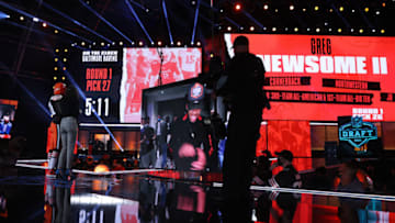 CLEVELAND, OHIO - APRIL 29: Mya Tomoto stands with NFL Commissioner Roger Goodell after announcing Greg Newsome II as the 26th pick by the Cleveland Browns during round one of the 2021 NFL Draft at the Great Lakes Science Center on April 29, 2021 in Cleveland, Ohio. (Photo by Gregory Shamus/Getty Images)