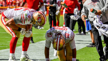 KANSAS CITY, MO - SEPTEMBER 23: George Kittle #85 of the San Francisco 49ers checks on injured teammate Jimmy Garoppolo #10 after a play in the fourth quarter of the game against the Kansas City Chiefs at Arrowhead Stadium on September 23rd, 2018 in Kansas City, Missouri. (Photo by Peter Aiken/Getty Images)