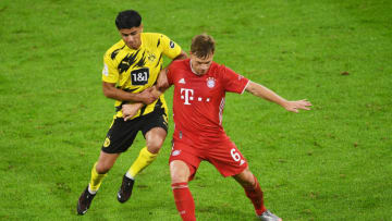 MUNICH, GERMANY - SEPTEMBER 30: Borussia Dortmund's Mahmoud Dahoud in action with Bayern Munich's Joshua Kimmich during the Supercup 2020 match between FC Bayern München and Borussia Dortmund at Allianz Arena on September 30, 2020 in Munich, Germany. (Photo by Andreas Gebert - Pool/Getty Images )
